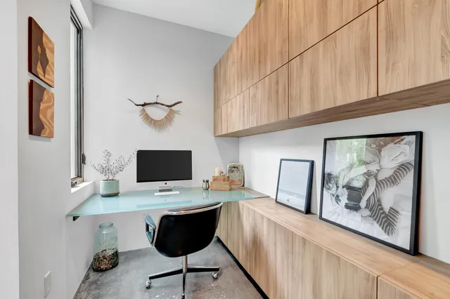 an aerial view of residential houses with outdoor space and trees