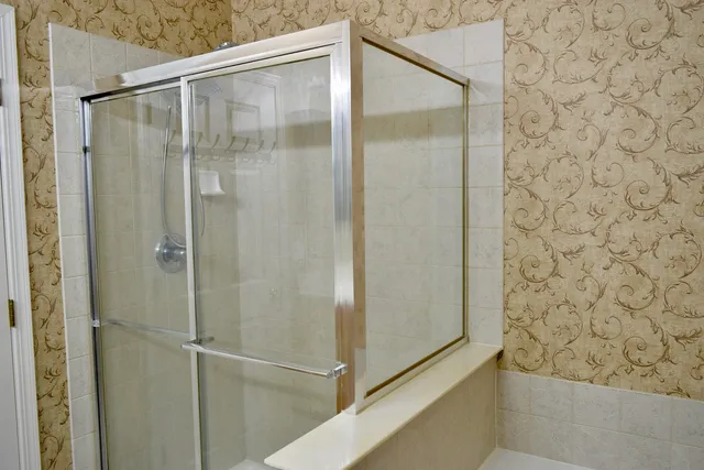 a bathroom with a glass shower door