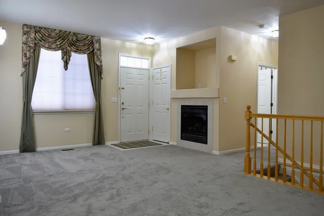 a view of a room with a fireplace and cabinet