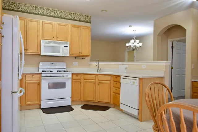 a kitchen with stainless steel appliances granite countertop a sink and dishwasher a stove with wooden floors