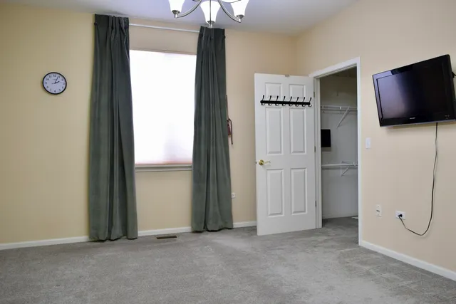 an empty room with windows and closet