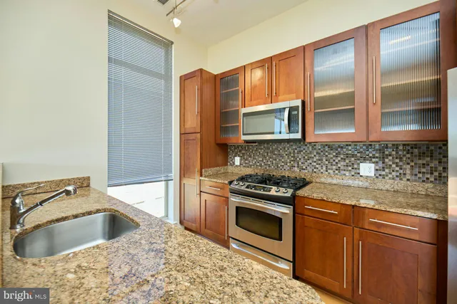 a kitchen with sink cabinets and microwave