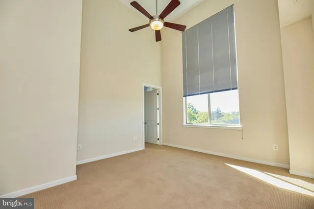 an empty room with windows and closet