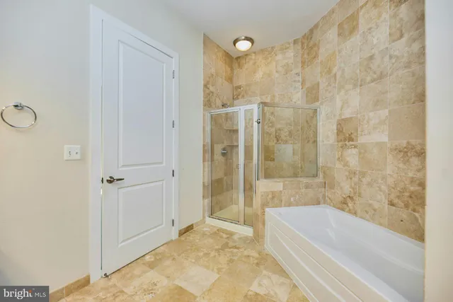 a bathroom with a bathtub and a shower