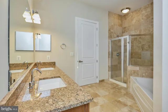 a bathroom with a tub sink and shower