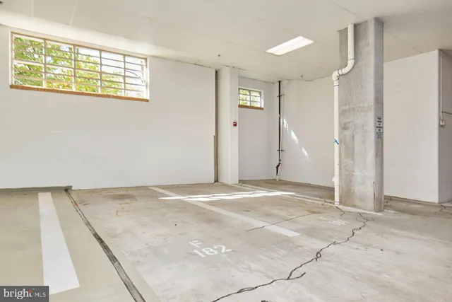 a living room with furniture a flat screen tv and kitchen view