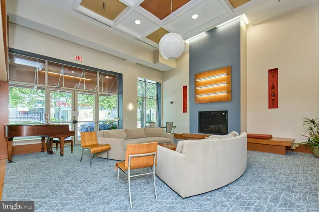 a kitchen with a dining table chairs and white walls