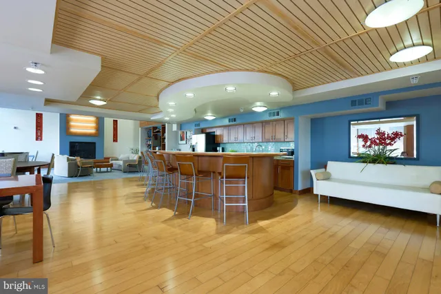 a kitchen with a dining table chairs and white walls