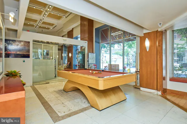 a kitchen with stainless steel appliances granite countertop a sink dishwasher stove and refrigerator with wooden cabinets