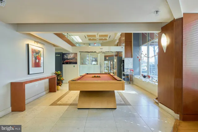 a view of a hallway with stainless steel appliances and cabinets