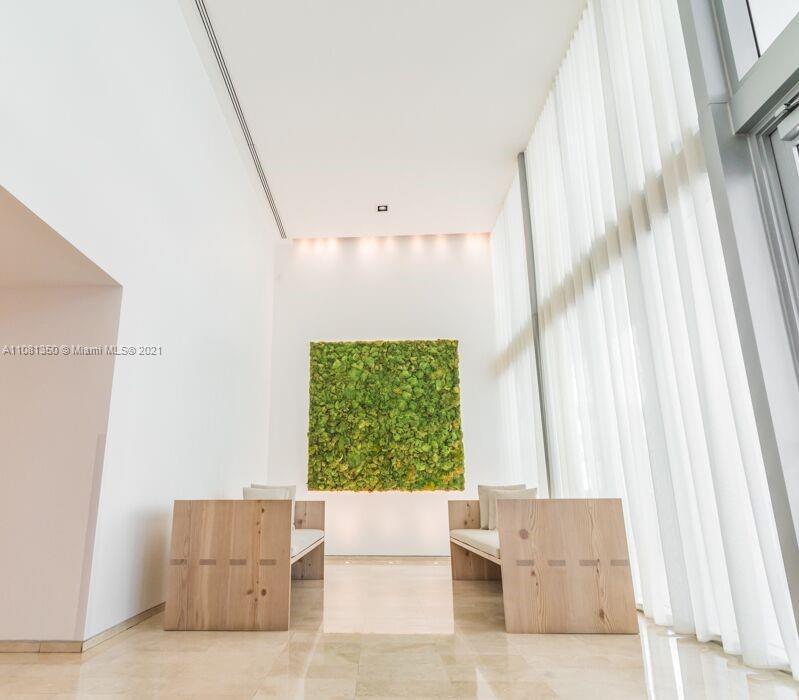 1040 Biscayne Boulevard, Unit 2403 Miami, FL 33132 - Photo 12 of 25 a living room with furniture and a large window