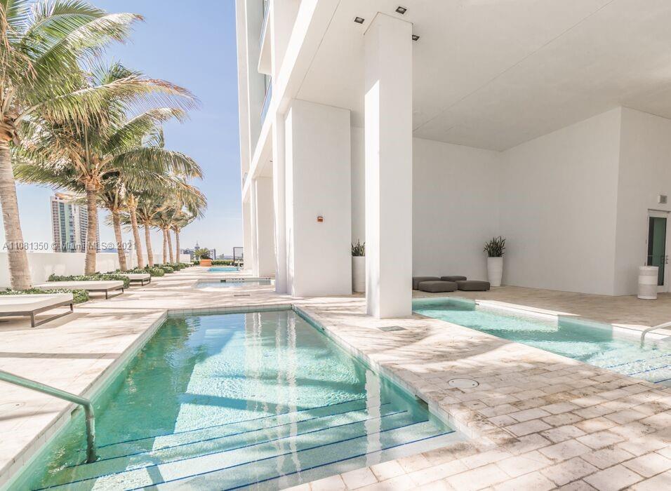 1040 Biscayne Boulevard, Unit 2403 Miami, FL 33132 - Photo 16 of 25 a swimming pool with yard and balcony view