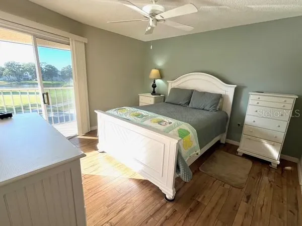 a bedroom with a bed and large windows