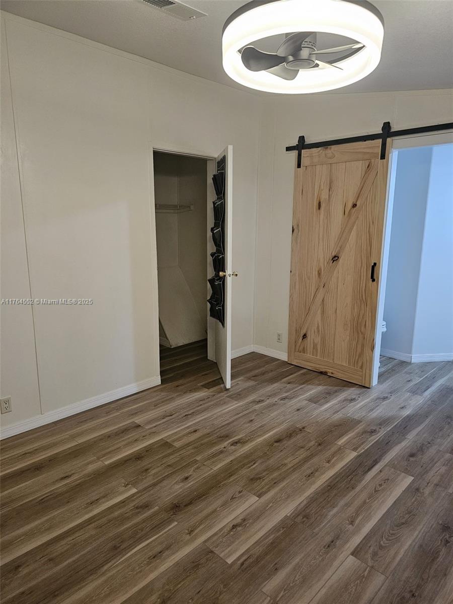 18520 Wildlife Trail Spring Hill, FL 34610 - Photo 11 of 12 a view of a room with wooden floor and white walls