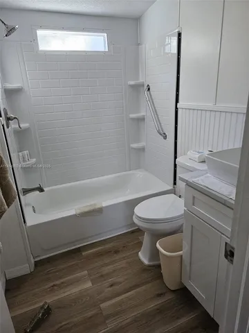a bathroom with a sink a toilet and a bathtub