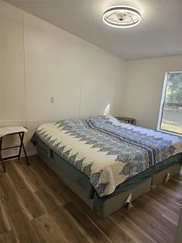 a bedroom with a bed and a table