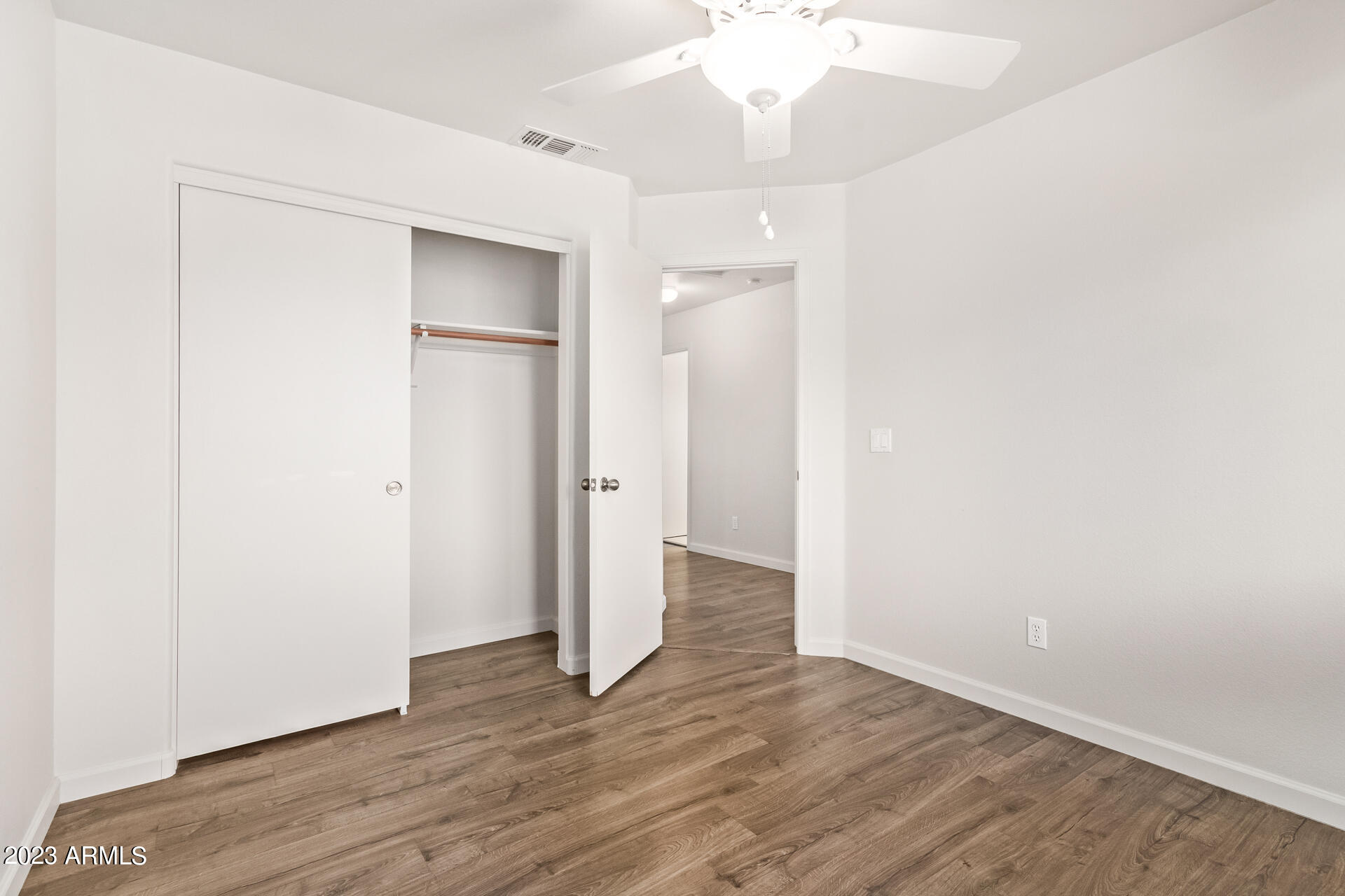 1310 East Angela Drive Phoenix, AZ 85022 - Photo 14 of 19 a view of an empty room with wooden floor