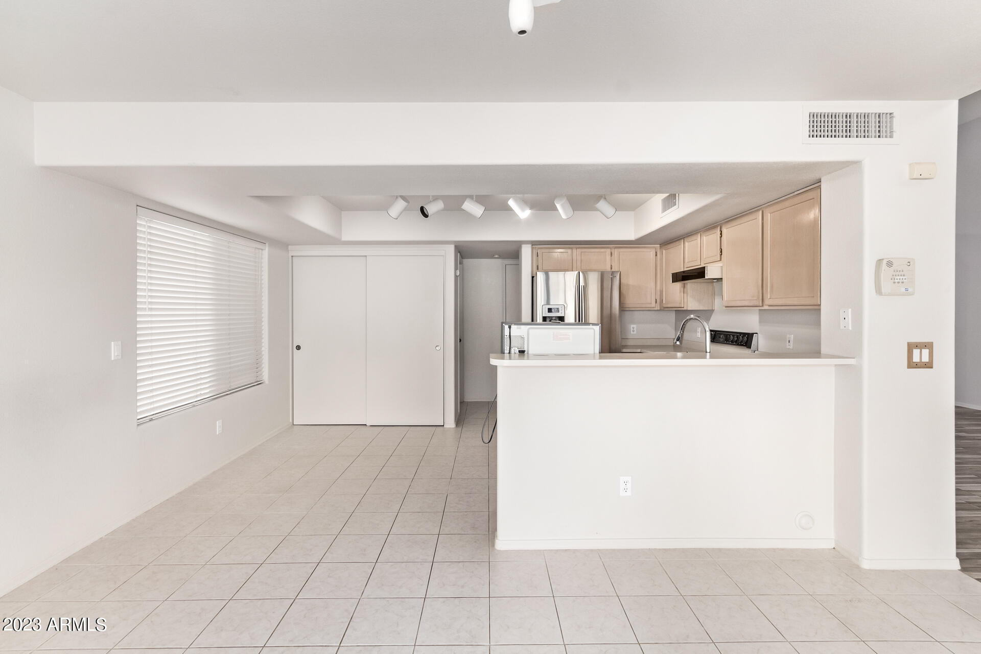 1310 East Angela Drive Phoenix, AZ 85022 - Photo 4 of 19 a view of a kitchen with an empty space and a window