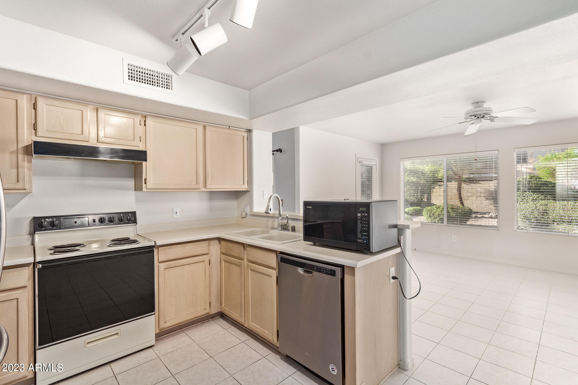 1310 East Angela Drive Phoenix, AZ 85022 - Photo 6 of 19 a kitchen with a stove sink and microwave