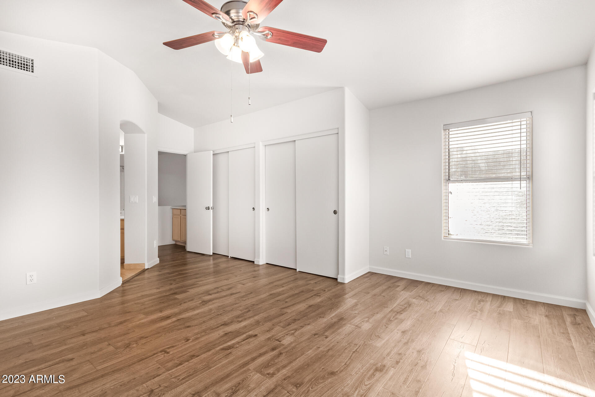 1310 East Angela Drive Phoenix, AZ 85022 - Photo 9 of 19 wooden floor in an empty room with a window