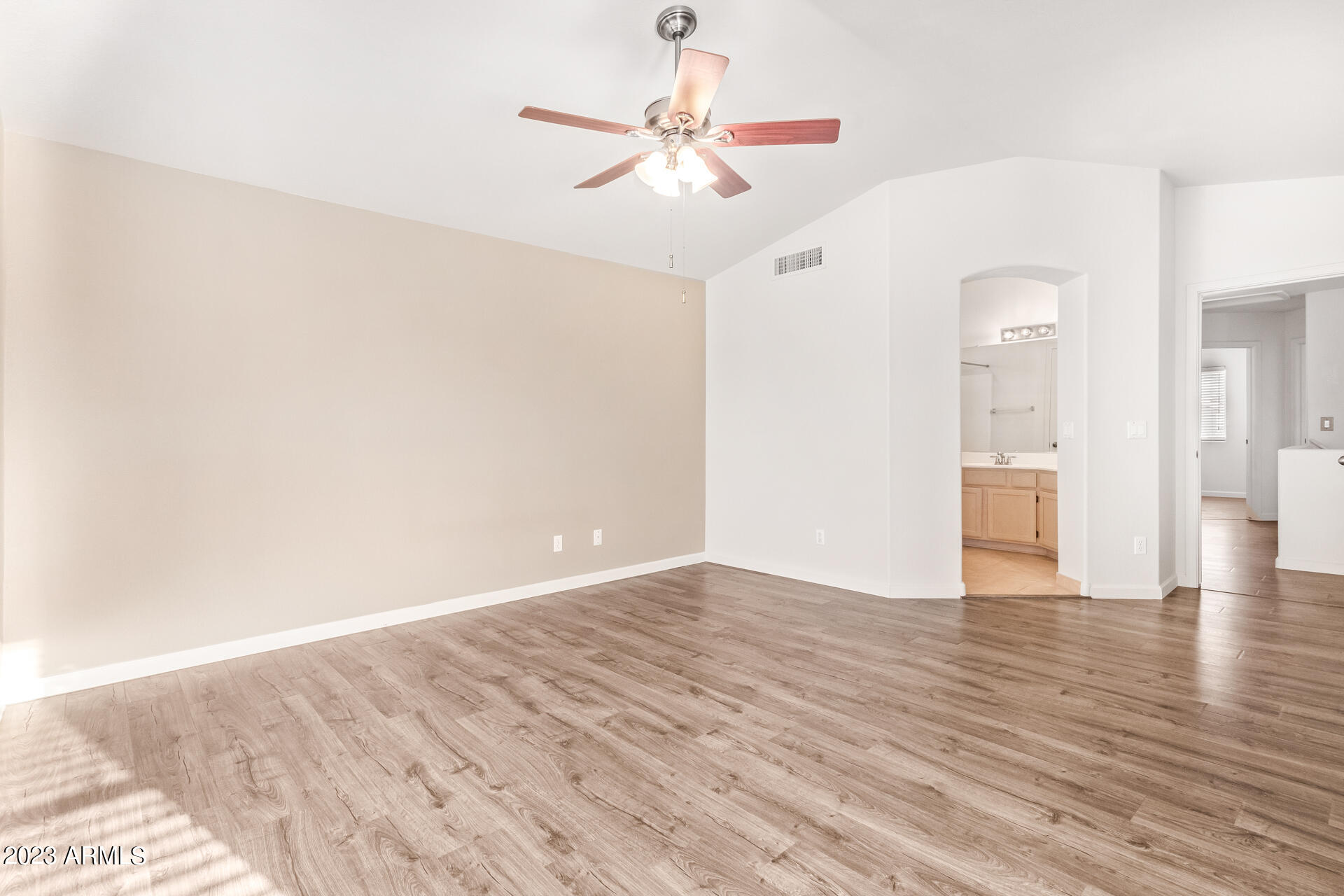 1310 East Angela Drive Phoenix, AZ 85022 - Photo 10 of 19 a view of an empty room with window and wooden floor