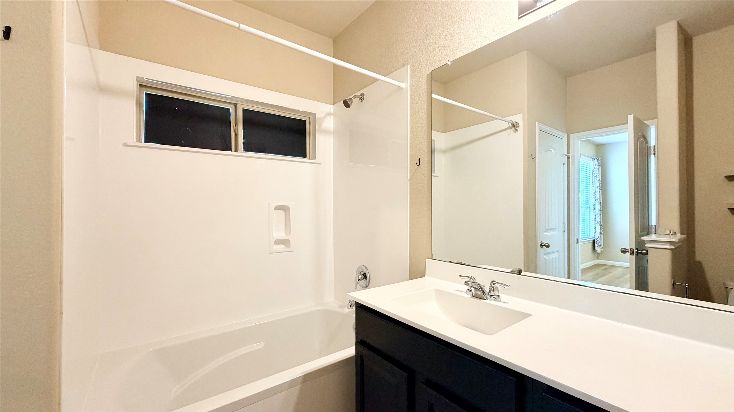 1437 Brooks Way Leander, TX 78641 - Photo 7 of 16 a bathroom with a sink a mirror and a bathtub