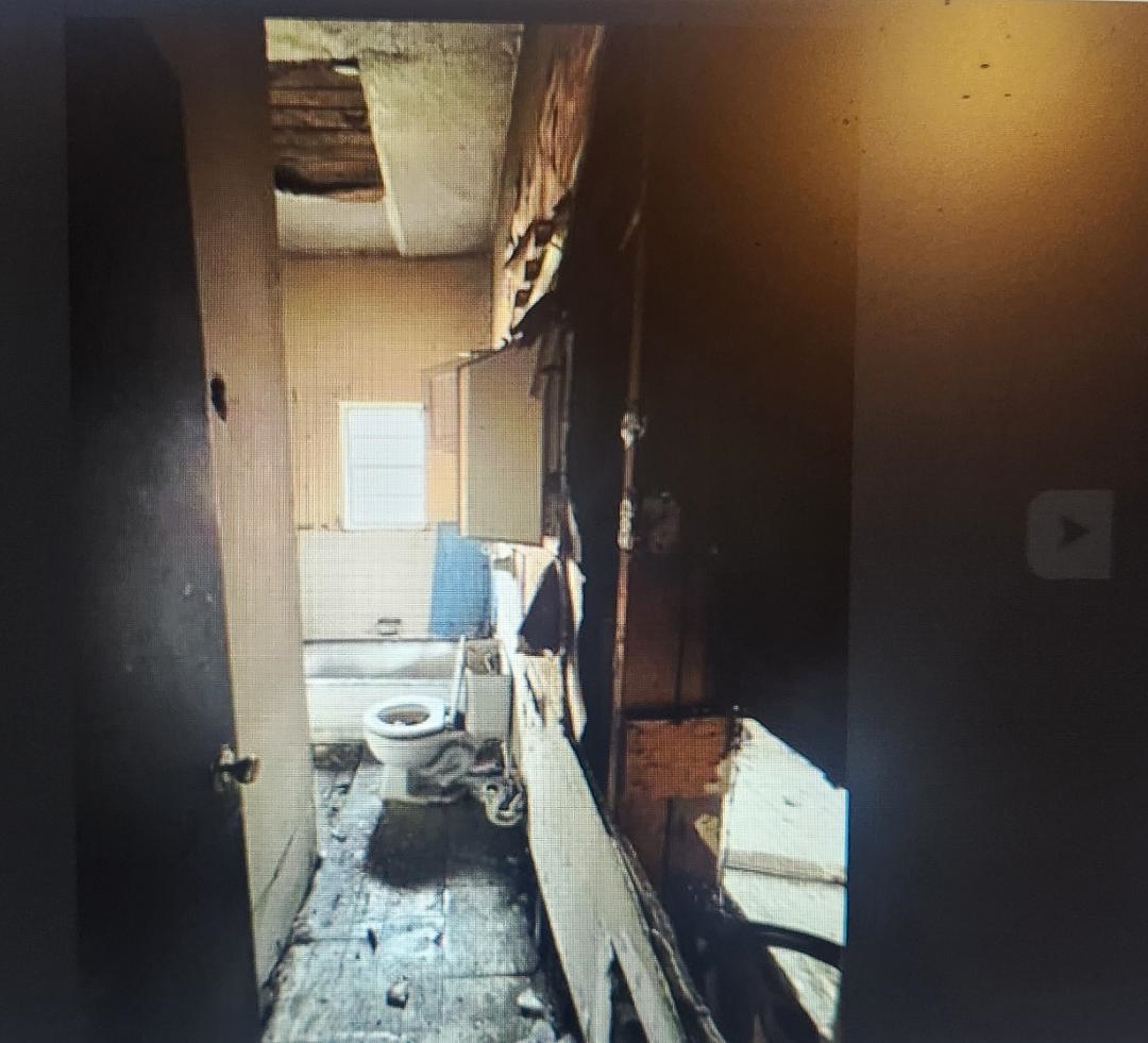 862 Mosby Avenue Memphis, TN 38105 - Photo 9 of 10 a bathroom with a sink toilet and a mirror