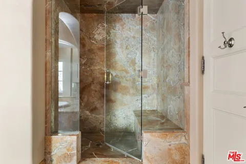 a bathroom with a glass shower door