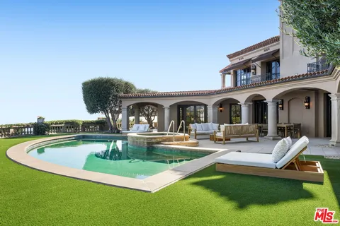 a view of a house with swimming pool and a yard