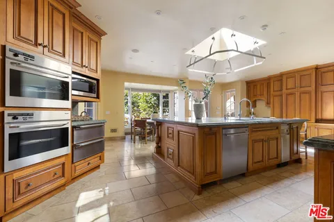 a kitchen with stainless steel appliances granite countertop a stove and cabinets
