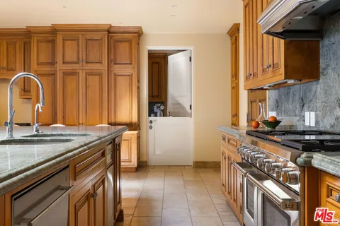 a kitchen with a stove and a sink