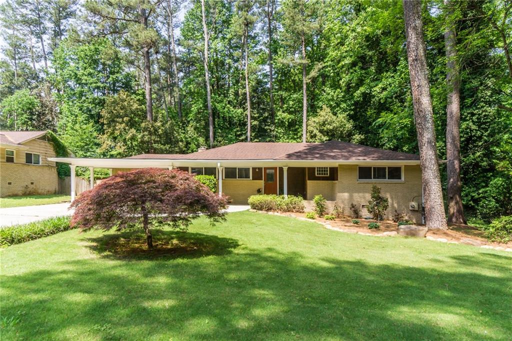 1970 Briarmill Road Northeast Atlanta, GA 30329 - Photo 1 of 1 a view of a house with backyard sitting area and garden