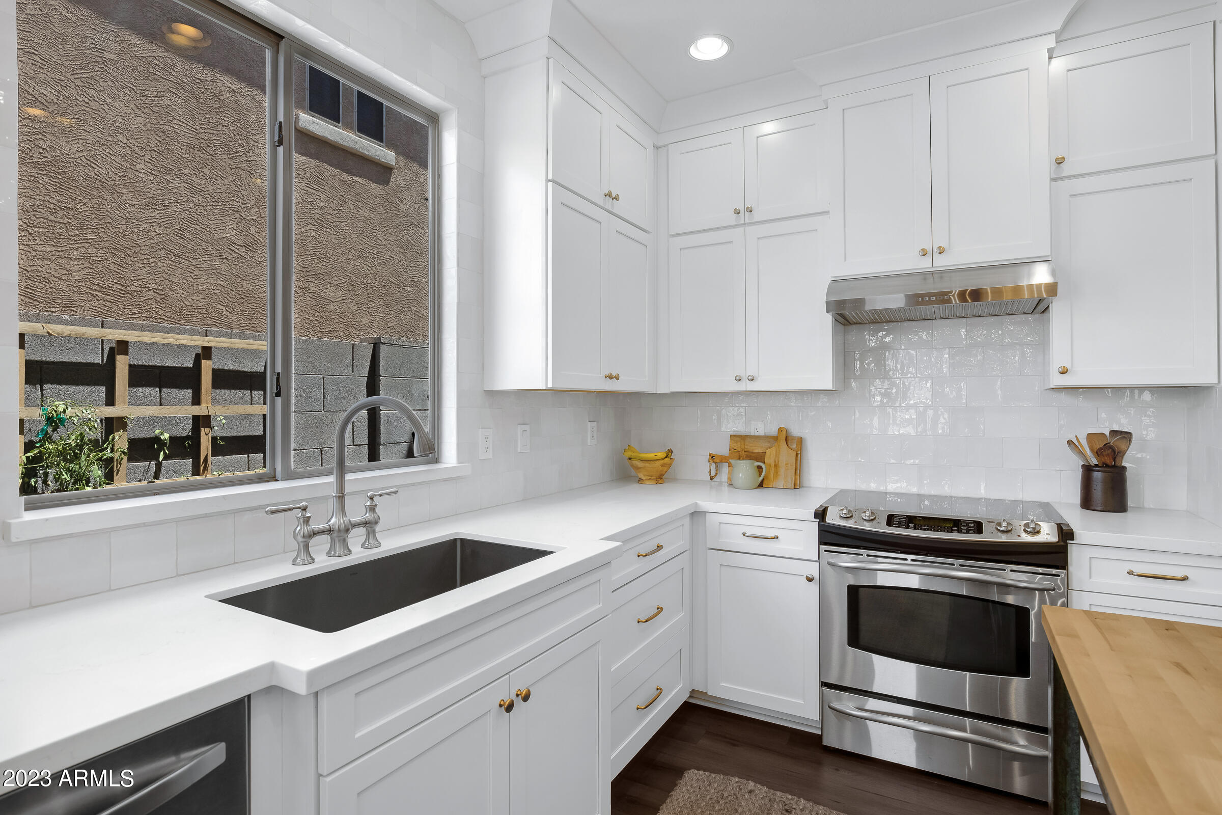 4736 East Timberline Road Gilbert, AZ 85297 - Photo 15 of 49 a kitchen with granite countertop a sink stainless steel appliances and cabinets