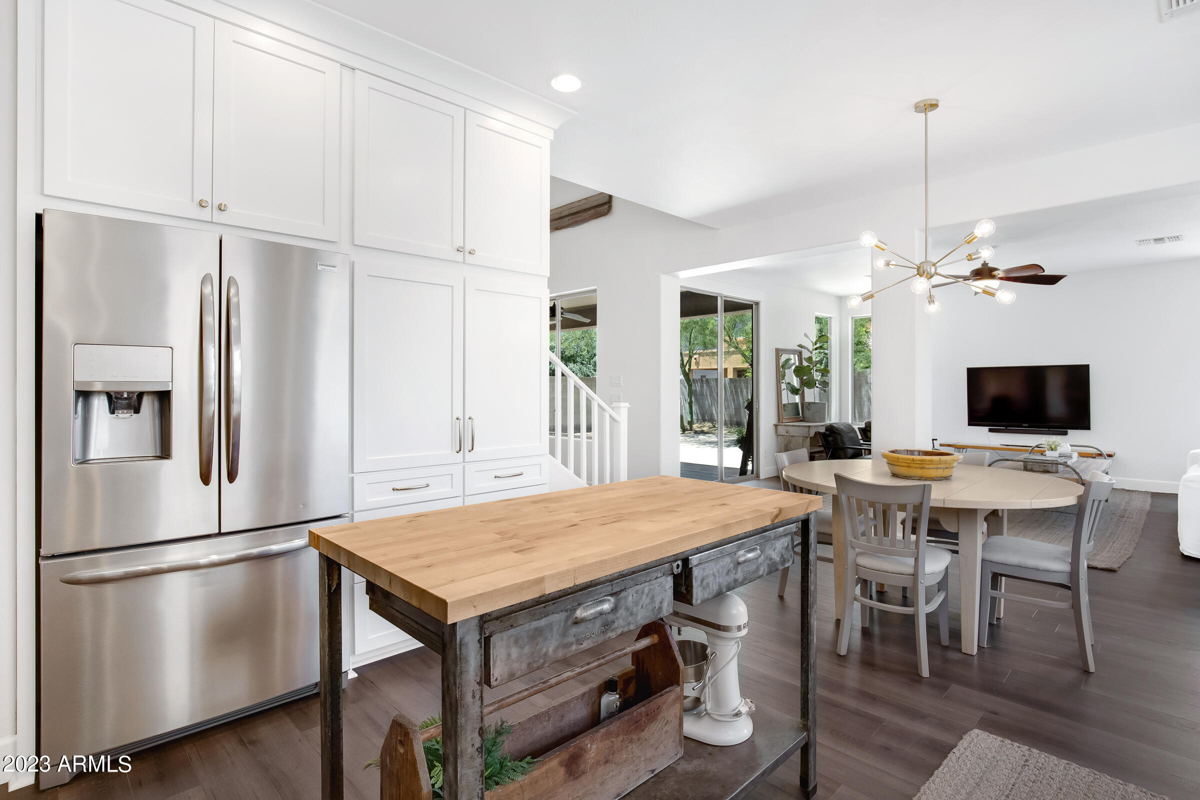 4736 East Timberline Road Gilbert, AZ 85297 - Photo 16 of 49 a kitchen with stainless steel appliances granite countertop a table chairs and a refrigerator