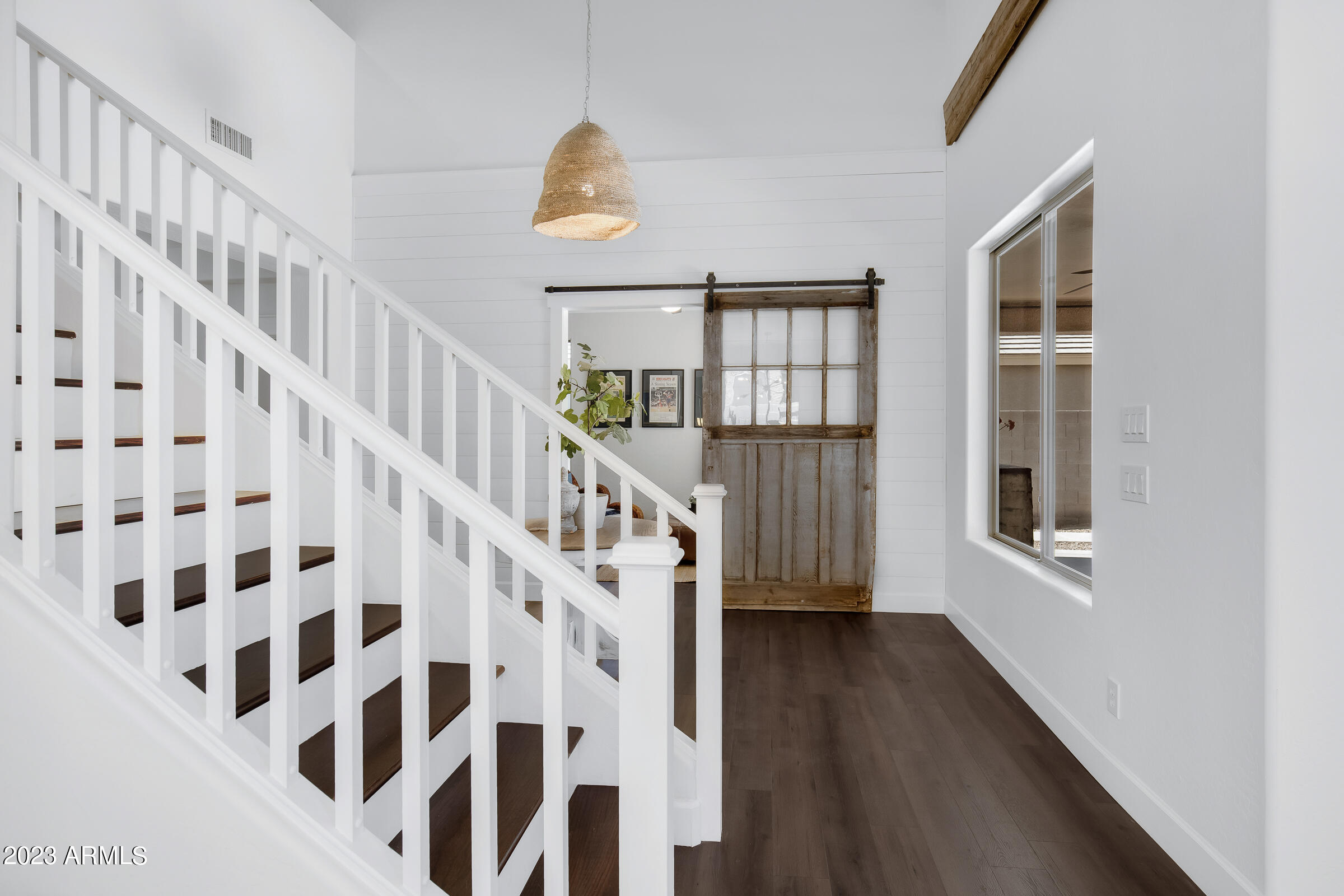4736 East Timberline Road Gilbert, AZ 85297 - Photo 22 of 49 a view of staircase with wooden floor and white walls