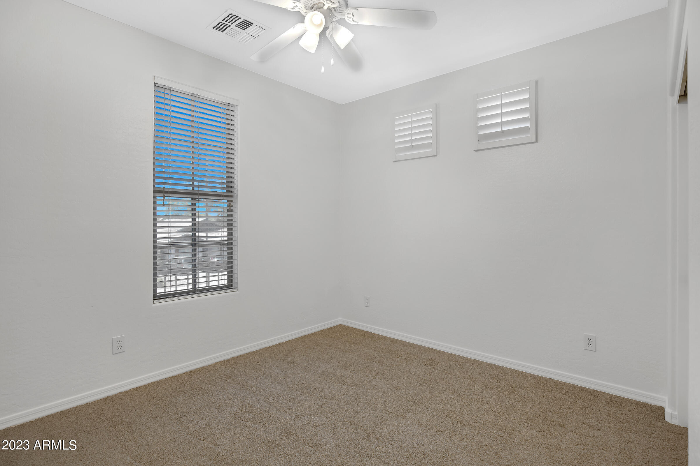 4736 East Timberline Road Gilbert, AZ 85297 - Photo 24 of 49 an empty room with windows and fan