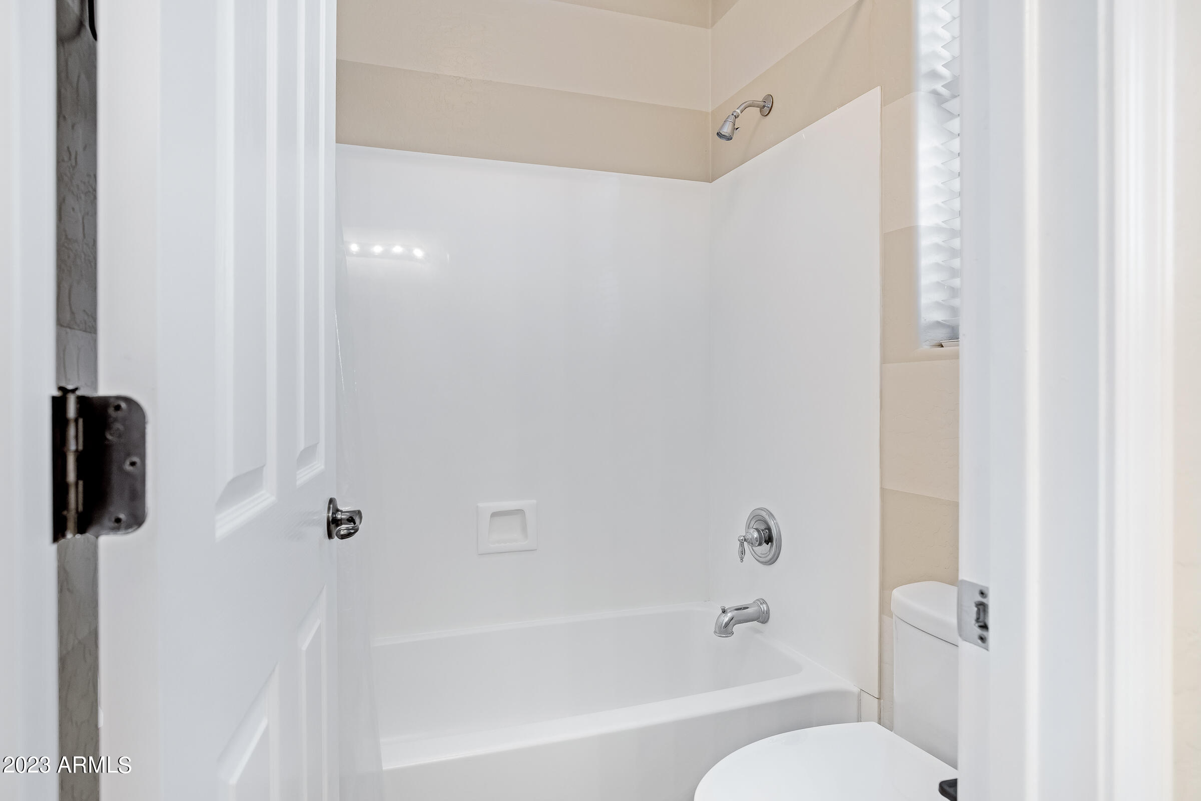 4736 East Timberline Road Gilbert, AZ 85297 - Photo 27 of 49 a bath room with a toilet and a bath tub