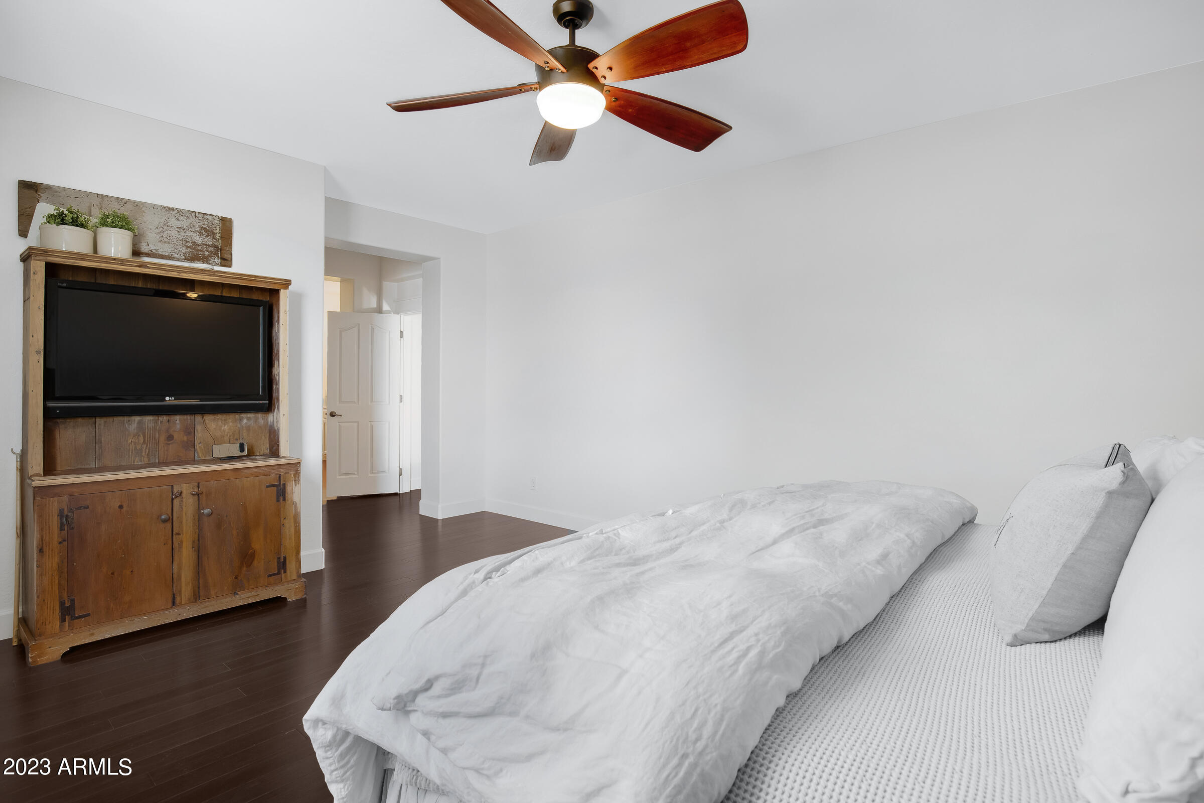 4736 East Timberline Road Gilbert, AZ 85297 - Photo 30 of 49 a bedroom with a bed and a flat tv screen on the dresser