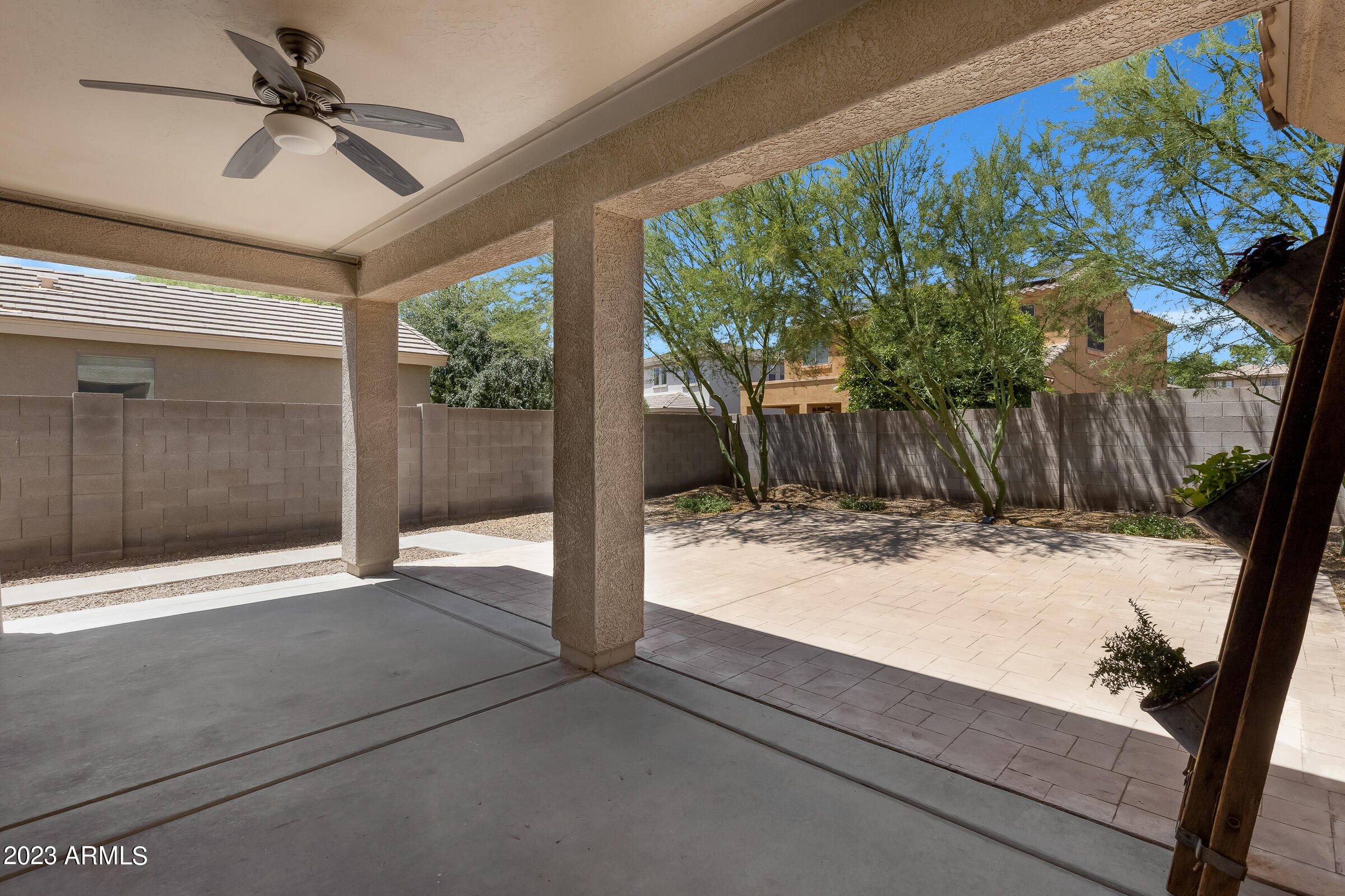 4736 East Timberline Road Gilbert, AZ 85297 - Photo 41 of 49 a view of backyard with large trees and wooden fence