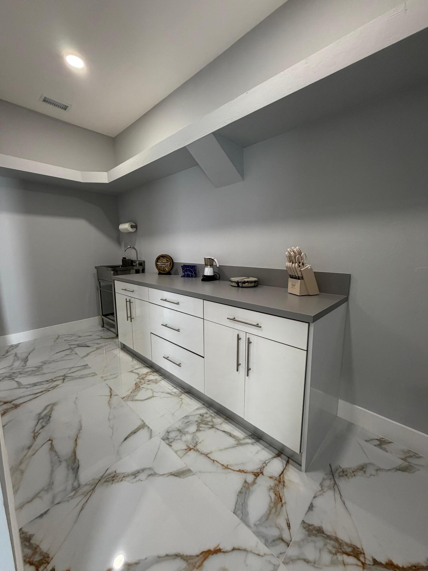 435 East A Road East LaBelle, FL 33935 - Photo 23 of 35 a kitchen with granite countertop a sink and cabinets