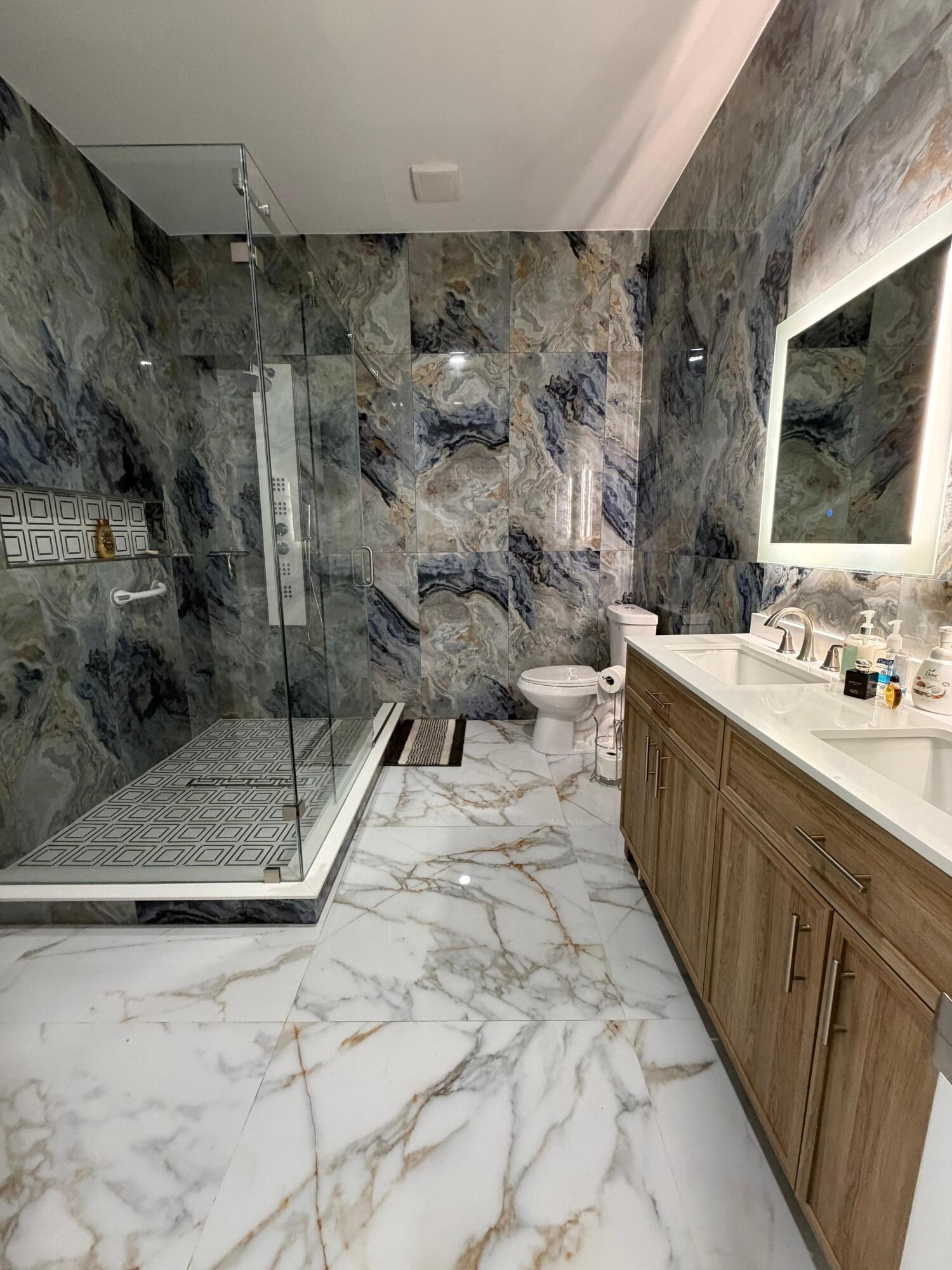 435 East A Road East LaBelle, FL 33935 - Photo 27 of 35 a spacious bathroom with a double vanity sink a mirror and a shower