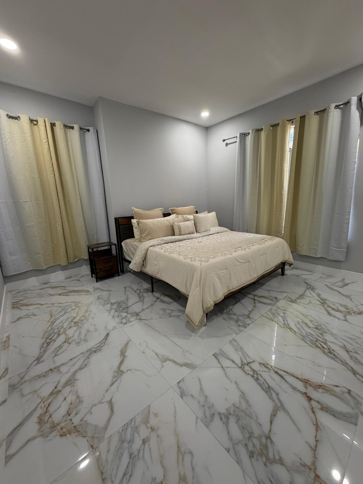 435 East A Road East LaBelle, FL 33935 - Photo 28 of 35 a bedroom with a bed and a mirror