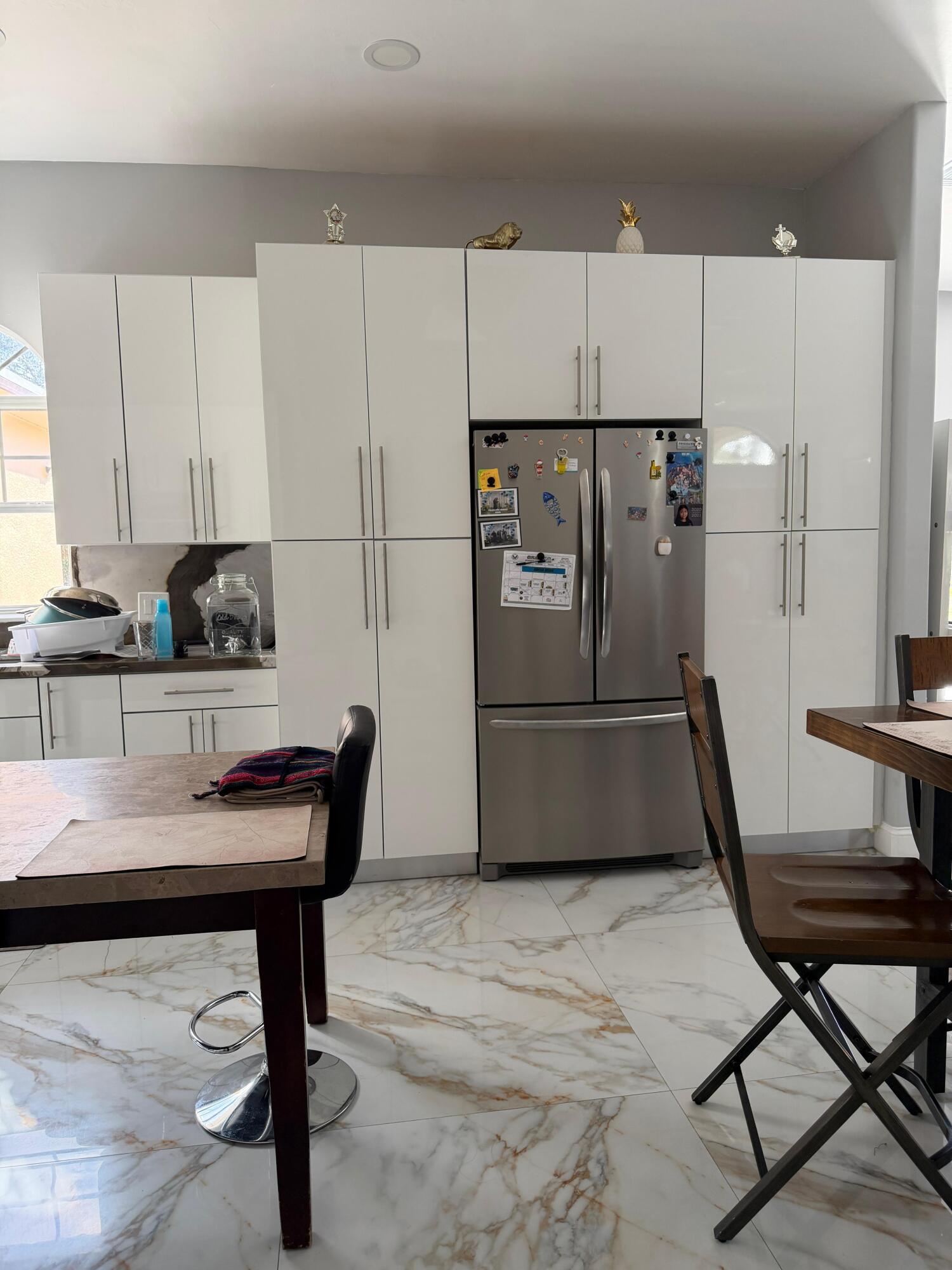 435 East A Road East LaBelle, FL 33935 - Photo 33 of 35 a kitchen with a refrigerator a stove a sink and chairs