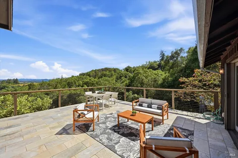 a view of a balcony with wooden floor and fence
