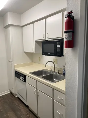 a kitchen with stainless steel appliances granite countertop a sink a stove and a microwave