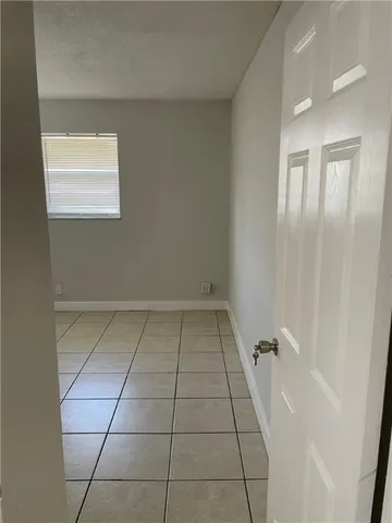 a view of a kitchen with white walls