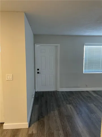 a view of an empty room and wooden floor