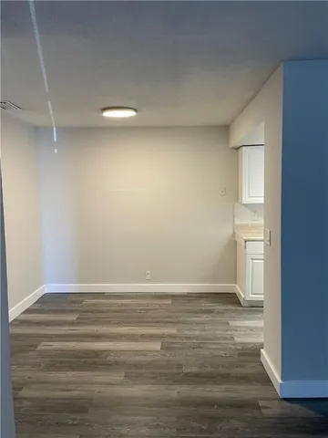 a view of room with window and wooden floor