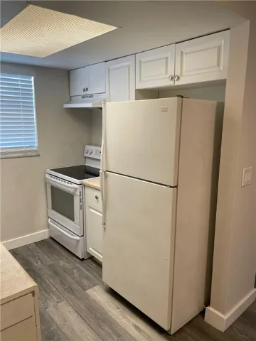 a white refrigerator freezer sitting in a kitchen
