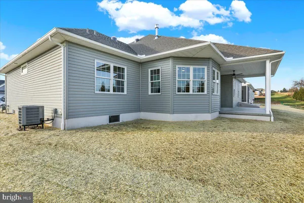 a house that has a large tree in front of it